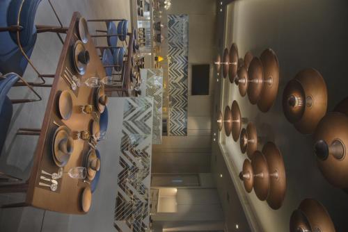 a room with a bunch of copper pans on the wall at Kabir Hotel & Spa in Vadodara