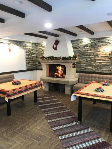 a room with two ping pong tables and a fireplace at Вила ИГЛИКА in Yagodina