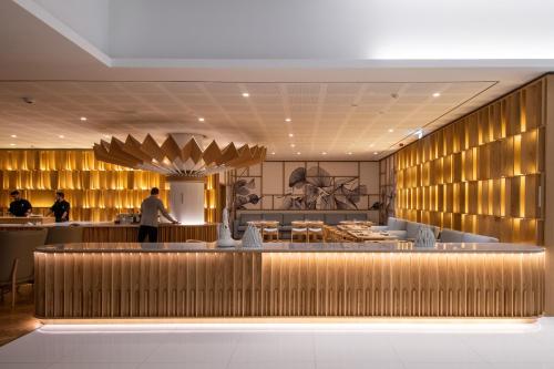 a lobby of a restaurant with a chef preparing food at EPIC SANA Algarve Hotel in Albufeira