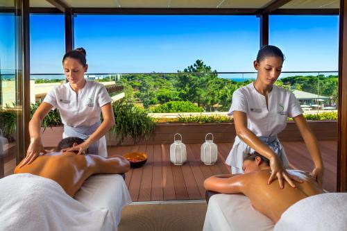 two women giving a man a massage at EPIC SANA Algarve Hotel in Albufeira
