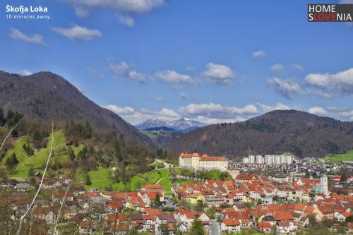 a town in a valley with mountains in the background at HomeSlovenia - your Home in the Heart of Slovenia in Selca