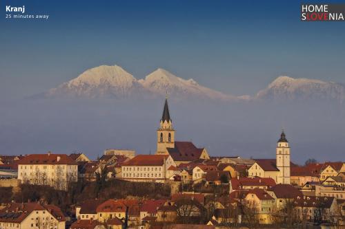 a city with buildings and mountains in the background at HomeSlovenia - your Home in the Heart of Slovenia in Selca