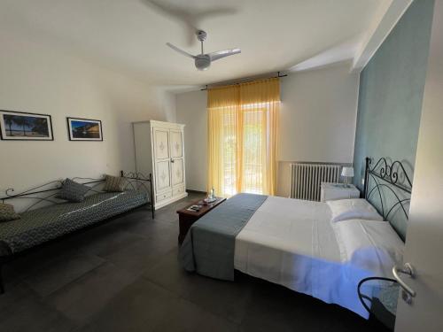 a bedroom with a large white bed and a couch at Antica Fonte holiday home in Tavullia