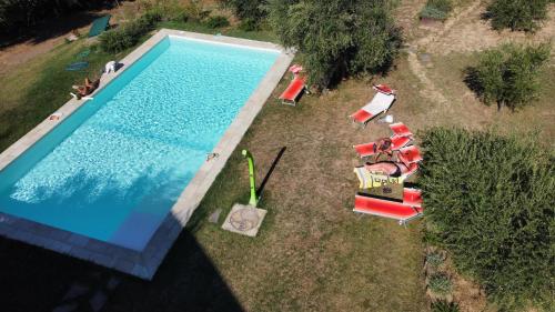 an overhead view of a swimming pool with chairs at Antica Fonte holiday home in Tavullia