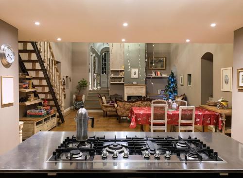 a kitchen and living room with a stove top at Podere Paradiso in Magione