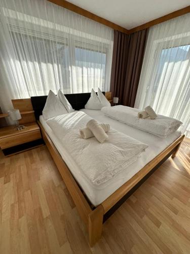 a bedroom with two beds with towels on them at Pension Alpina in Roppen