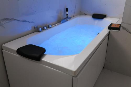 a white bath tub with a black seat in it at PRESTIGE BOUTIQUE APARTHOTEL -Piazza Duomo in Milan