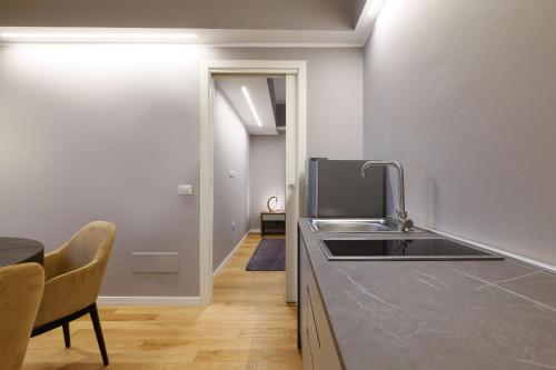 a kitchen with a sink and a counter top at PRESTIGE BOUTIQUE APARTHOTEL -Piazza Duomo in Milan