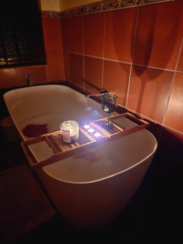 a bath tub with a candle in the middle of it at Imasiku House in Southbroom