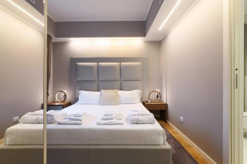 a bedroom with a large bed with towels on it at PRESTIGE BOUTIQUE APARTHOTEL -Piazza Duomo in Milan