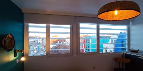 two windows in a room with a view of a city at Aveiro Rossio Lodge in Aveiro