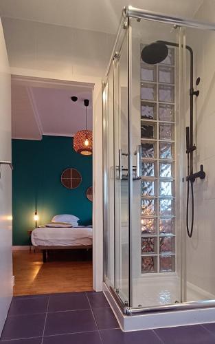 a bathroom with a glass shower and a bed at Aveiro Rossio Lodge in Aveiro