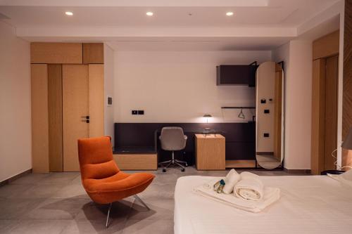 a hotel room with a bed and a chair at Spazio Corrado in Corigliano Calabro