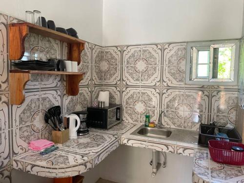 a kitchen with a sink and a counter top at GraceWay Studio Apt with A/C -3mins walk to beach in Negril