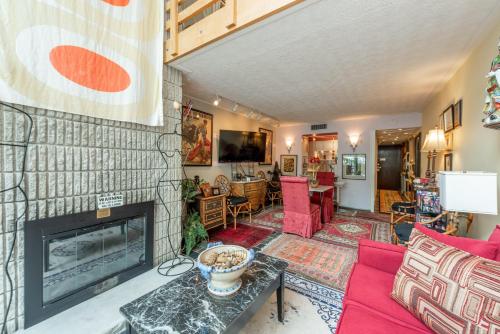 a living room with a fireplace and a red couch at 307C One Bedroom One Bath in Oakland