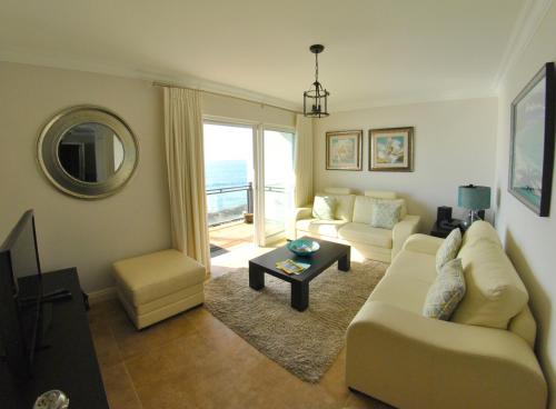 a living room with a couch and a table at Apartamentos 3 Praias in Ponta Delgada