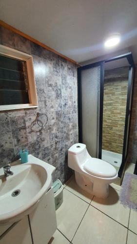 a bathroom with a toilet and a sink at Hostal El Baltico in Castro