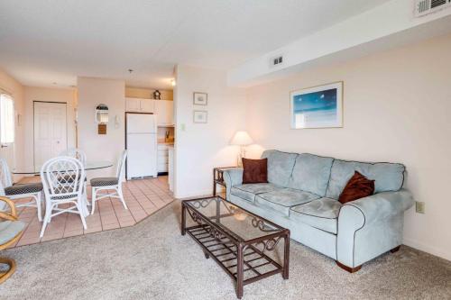a living room with a couch and a table at Marylander Condominiums, 90 steps from the beach in Ocean City