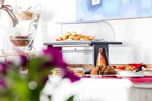 a counter with bread and pastries on a table at Calma Luxury Rooms in Split