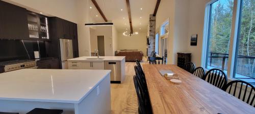 a large kitchen with a wooden table and chairs at Fernie Escape - Mountain Home on the Ski Hill in Fernie