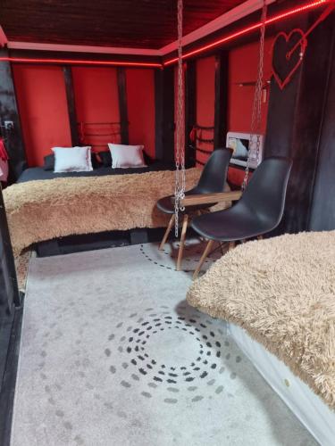 a room with two beds and a table and chairs at Stefan cel Mare studio in Chişinău