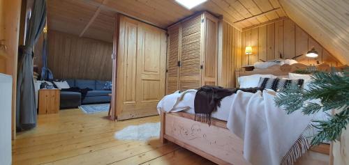 a bedroom with a bed and a living room at Willa Pod Giewontem in Zakopane