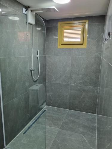 a bathroom with a shower with a glass door at Casa Ferreira Cumbuco in Caucaia
