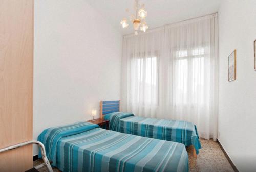 威尼斯的住宿－威尼斯吉奧伊奧薩公寓，一间卧室设有两张床和窗户。