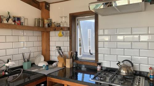 a kitchen with a sink and a stove and a window at Arenaguas Beach Front House in Matanzas
