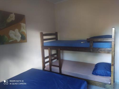 a room with two bunk beds and a desk at Chácara Espaço Feliz in Olímpia