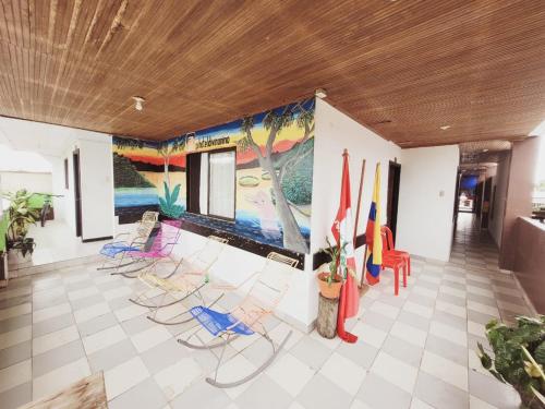 a room with chairs and a painting on the wall at Divino Niño Hotel in Leticia