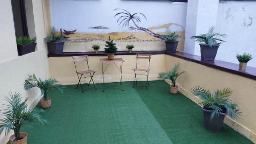 a room with chairs and a table and potted plants at Ambiennt in Bucharest