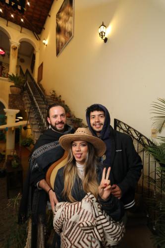 a group of people standing on the stairs at Hostel Cultural Pata y Perro in Tarija
