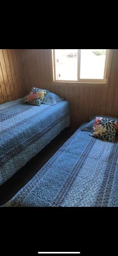 מיטה או מיטות בחדר ב-Cabaña Aldi