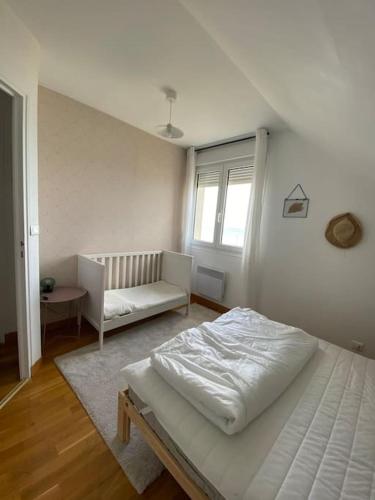 a white bedroom with a bed and a couch at Grande maison chaleureuse avec vue mer imprenable in Criel-sur-Mer
