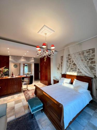 a bedroom with a large bed and a chandelier at Casa da Sogno Elegant Studio in Nafpaktos