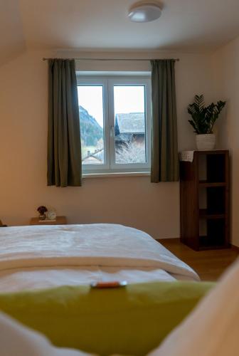 a bedroom with a large bed and a window at s`Hauserl 311 - Your Austrian Home in Altaussee