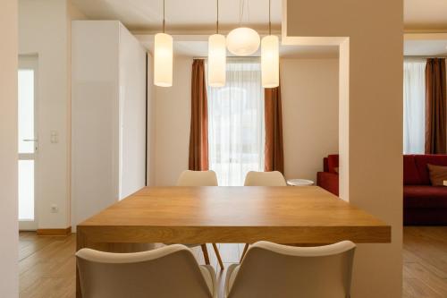 a dining room with a wooden table and chairs at La Bella Centrum apartmanok Piros/Sárga in Hévíz