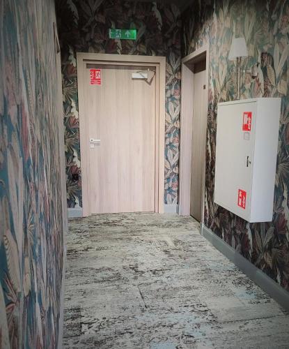 an empty room with a door and colorful wallpaper at Pensjonat Retro in Łomża
