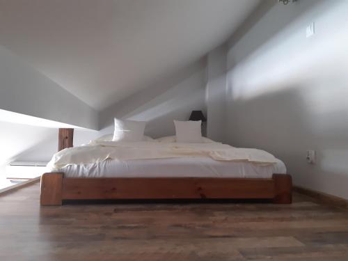 a bedroom with a white bed in a attic at Apartamenty Za Winklem in Krakow