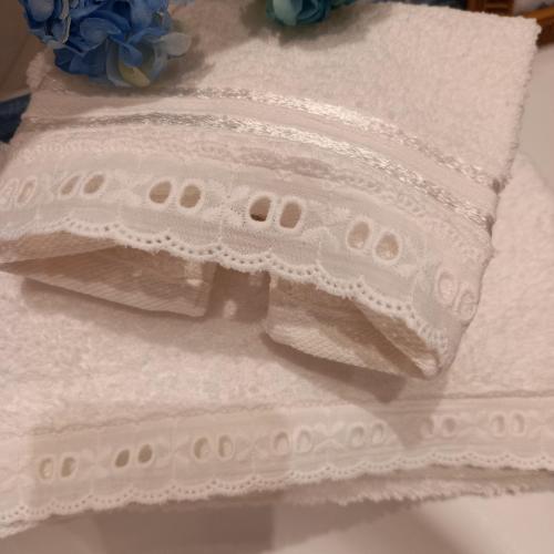 a pile of white towels sitting on a table at Casa da Sogno Elegant Studio in Nafpaktos