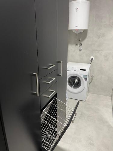 a small bathroom with a washing machine in it at Villa D&M in Krupanj