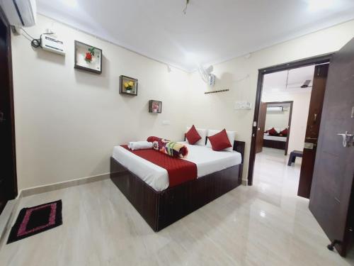 a bedroom with a bed with red pillows at MK SUITES in Hyderabad