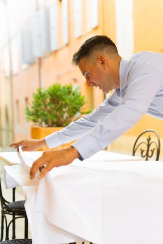 a man sitting at a table in front at Locanda Del Feudo Suite & Restaurant in Castelvetro di Modena