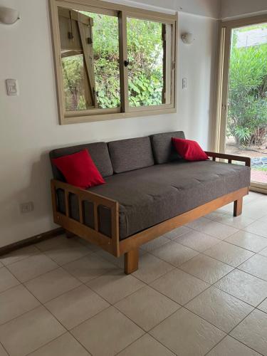 a couch with two red pillows in a room at Casa en Chacras de Coria - zona de Bodegas in Ciudad Lujan de Cuyo