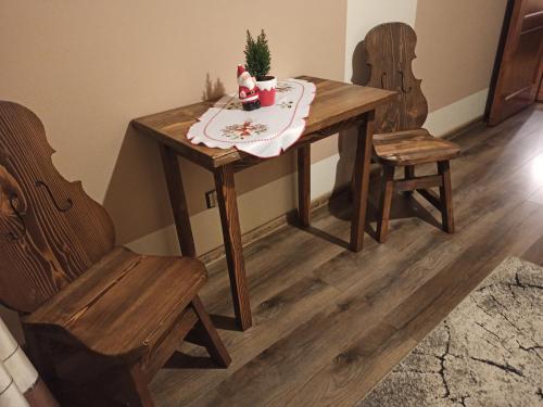 a dining room table with a christmas tree on it at Muzyczny Dworek in Rzepiska