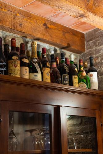a bunch of bottles sitting on top of a cabinet at Locanda Del Feudo Suite & Restaurant in Castelvetro di Modena