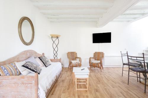 a living room with a couch and a tv at Le Moulin de Dannemarie in Dannemarie