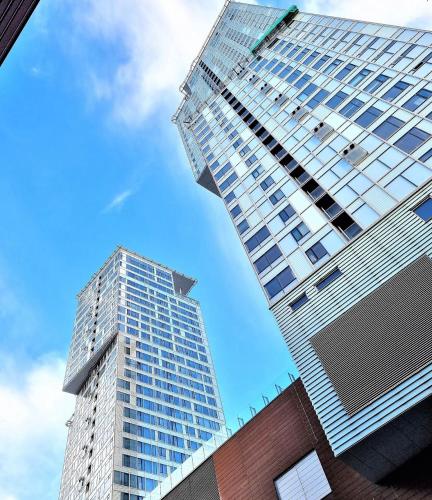 two tall buildings standing next to each other at Fabulous Morden Apartment in Helsinki in Helsinki