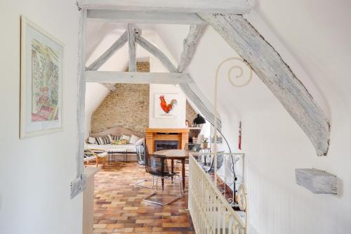 a room with a staircase and a living room at Le Moulin de Dannemarie in Dannemarie